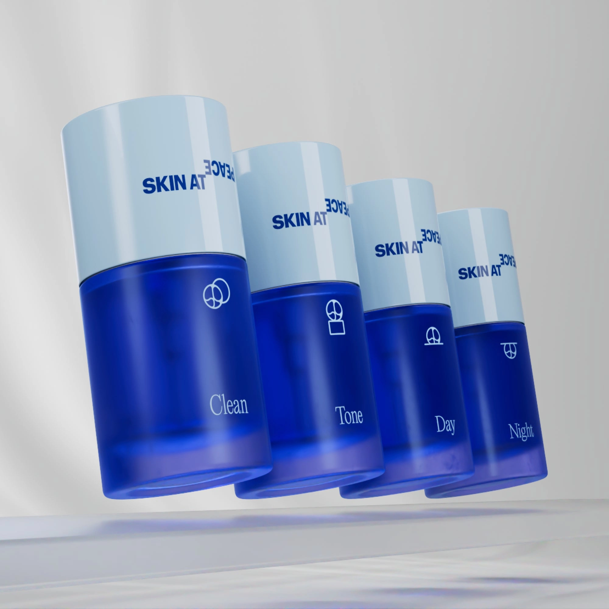 The four Skin at Peace bottles in a row: Clean, Tone, Day, and Night, with light blue caps.